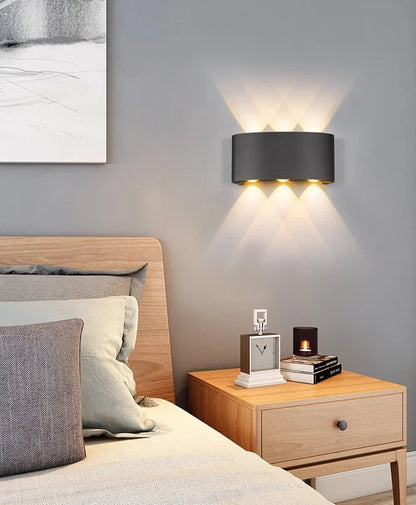 Waterproof black aluminium LED wall lamp 4W warm white emitting 60-degree beam angle mounted on white wall