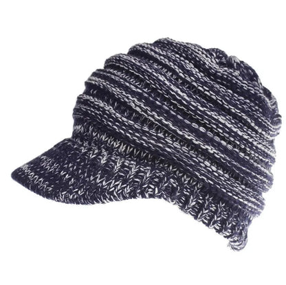 Woman wearing a light grey knitted ponytail beanie with her ponytail pulled through the hole in the back.