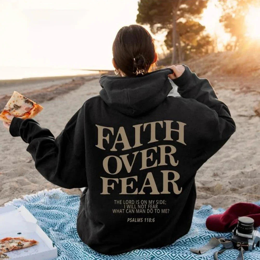 A stylish Christian hoodie with inspirational graphics and a message of faith over fear