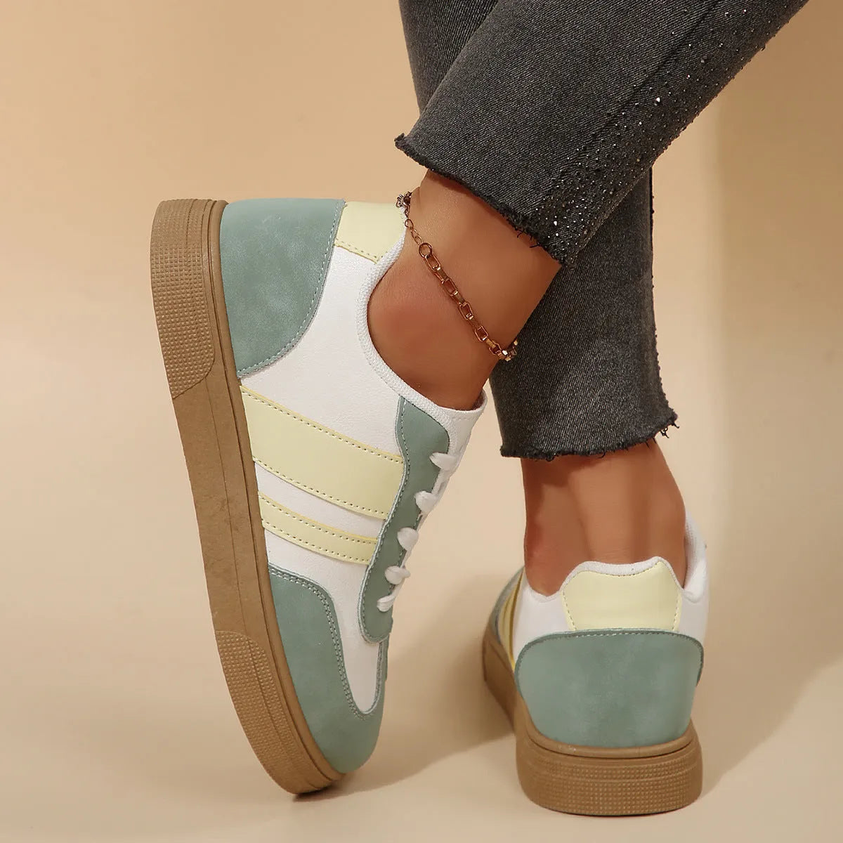 Green women's low-top retro sports shoes with cross-strap design and round toe.