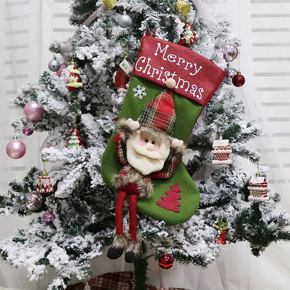 Set of three large red, white, and brown Christmas stockings with 3D Santa, Snowman, and Reindeer designs hanging on a tree.