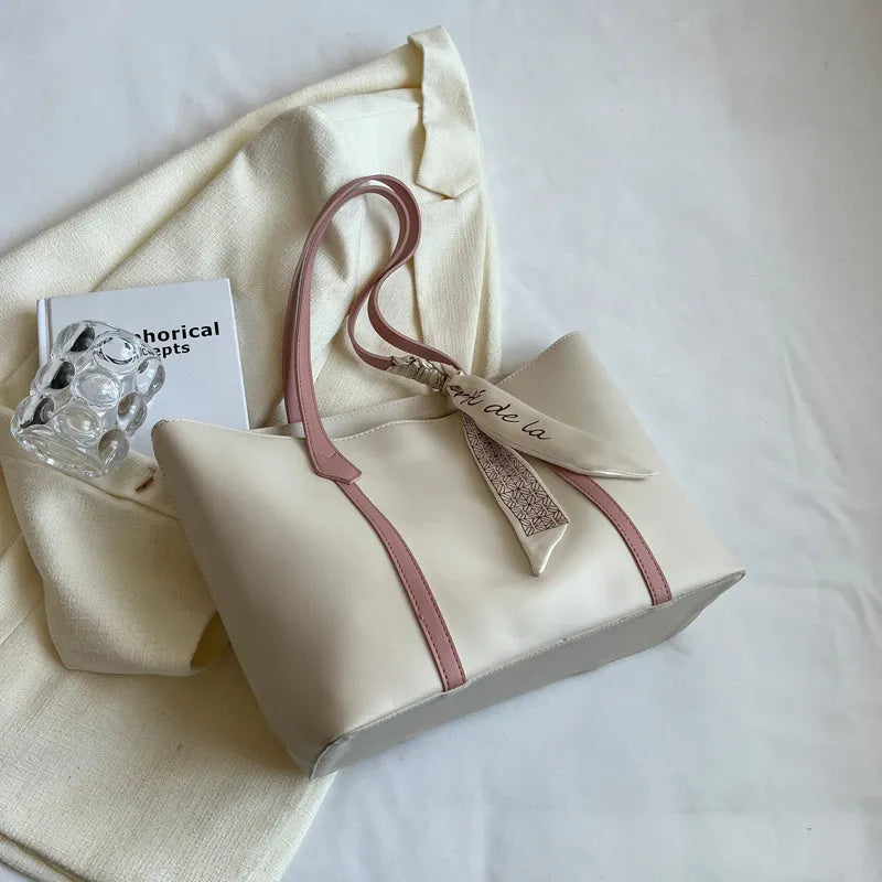 Soft large-capacity bucket tote bag with shoulder strap and zip pocket, shown in a neutral colour.