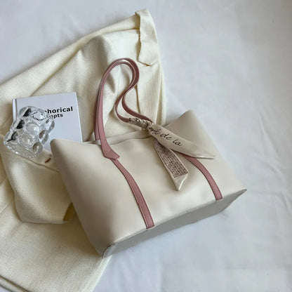 Soft large-capacity bucket tote bag with shoulder strap and zip pocket, shown in a neutral colour.