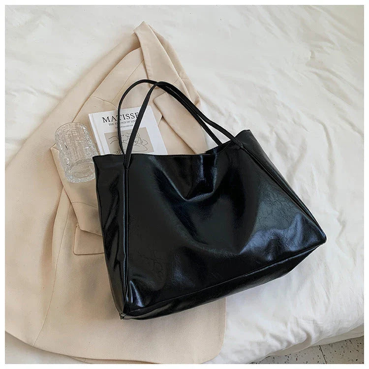 Stylish leather shoulder bag in various colors, including wine red, blue, black, brown, and beige. Showcases a versatile and spacious design for everyday use.