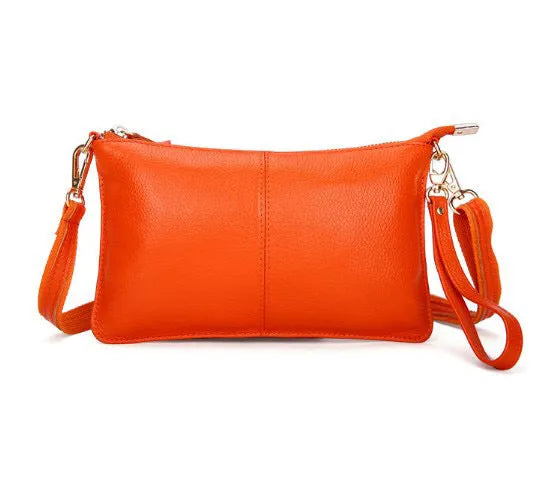 Lady's cowhide slant bag in apricot colour showing front view with strap and compact 24 cm size.