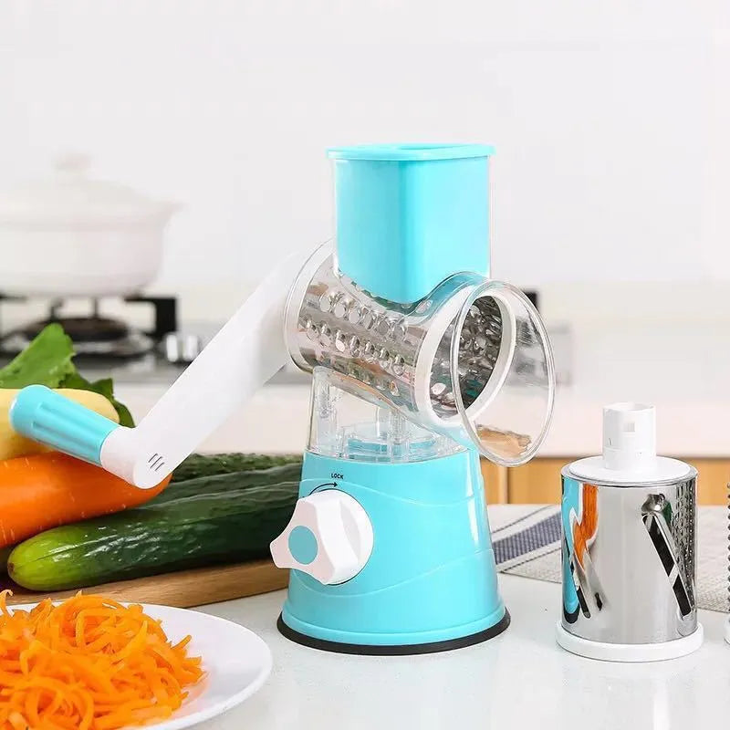 Hand drum rotary grater with handle and food-grade stainless steel blades, shown in Blue, Green or Red for cutting carrots and potatoes.