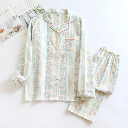 Red fruit print cotton gauze ladies' pyjama set with long sleeves and trousers laid flat.