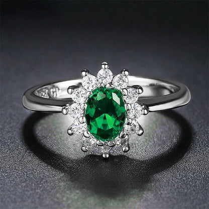 A women's copper ring with a flower design and a central zirconium stone, shown in green, blue, and red colour options.
