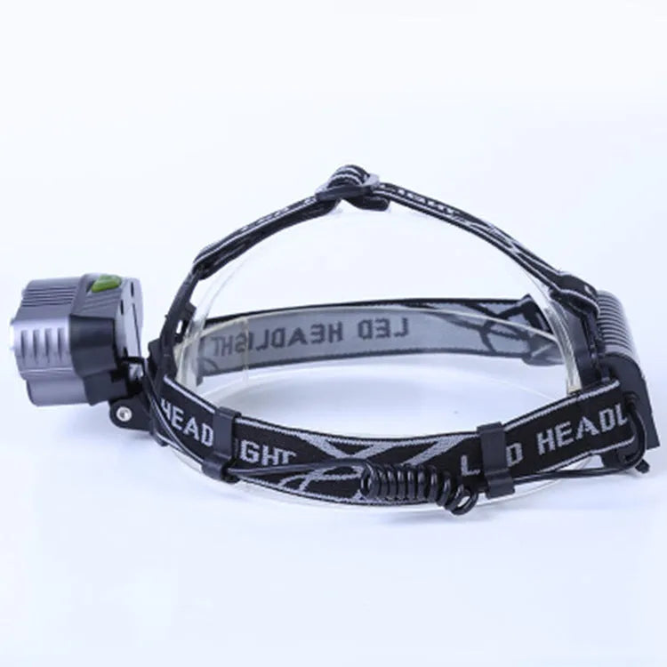 Fixed focus head torch for camping with long-range LED beam, shown with charger.