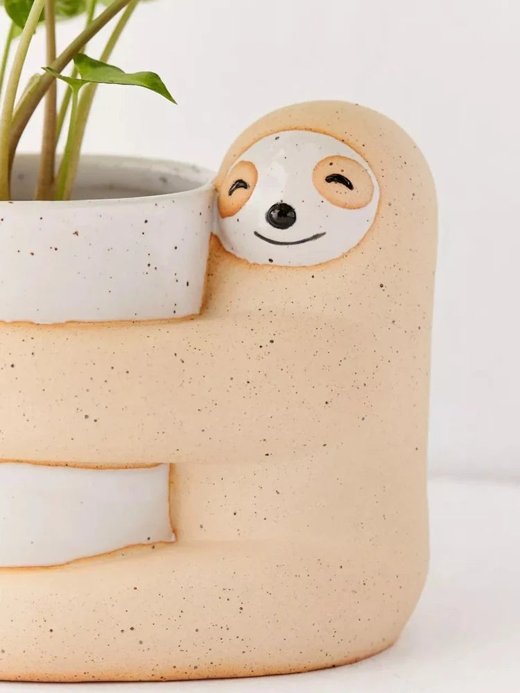 Ceramic sloth flower pot with drainage holes measuring 13.5cm height