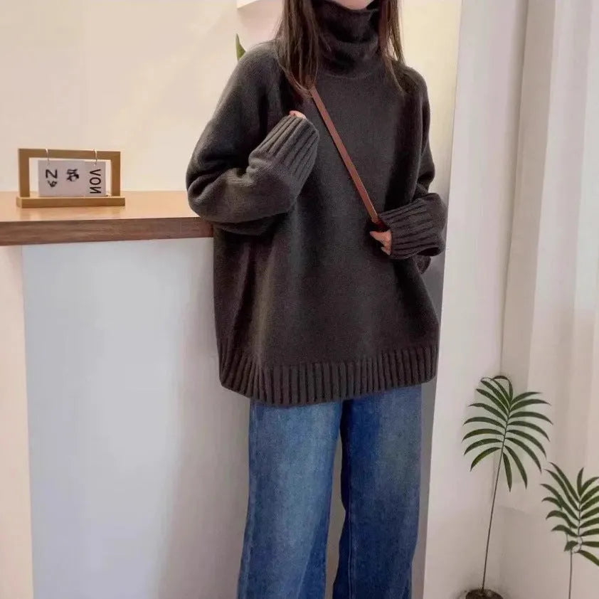 Women's turtleneck sweater in loose fit with thick curling pile collar, available in red, camel, grey, and black colours