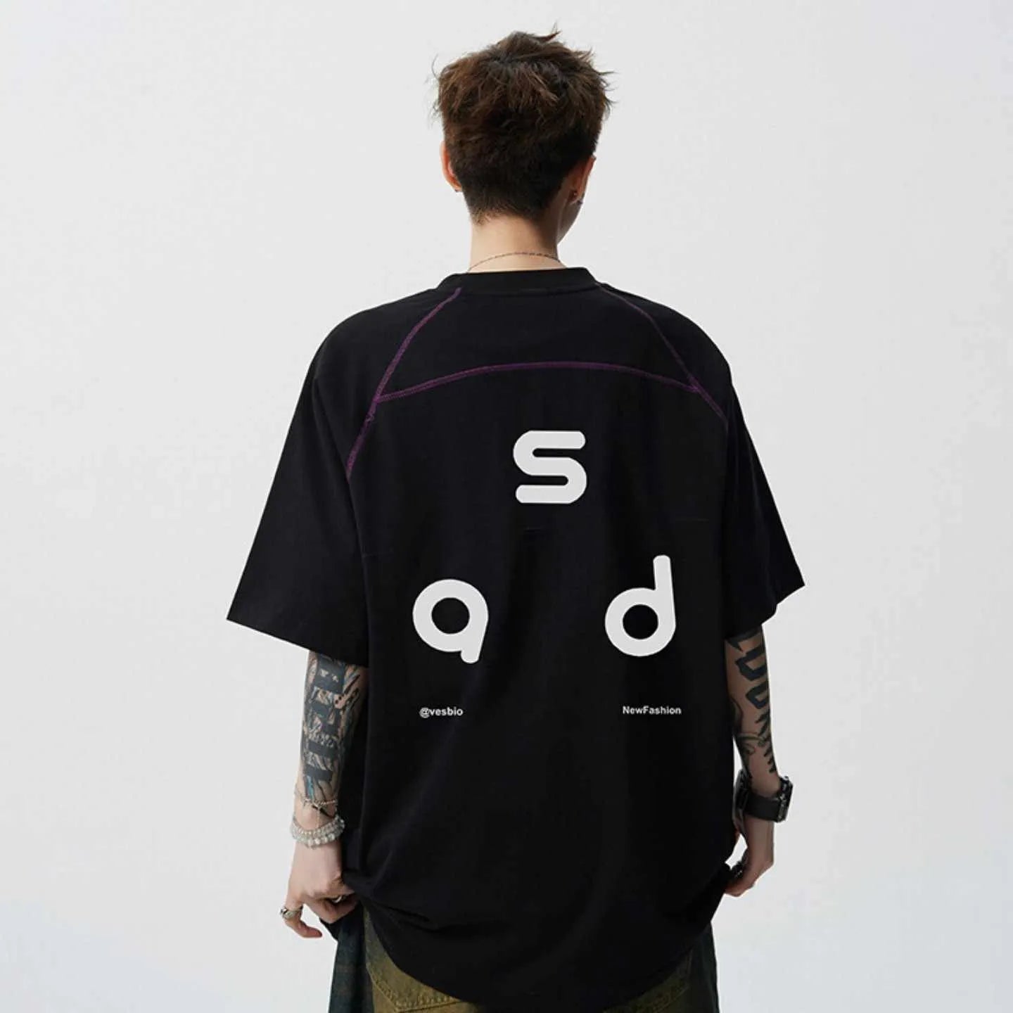 Black loose fit cotton T-shirt with white letter print on front, short sleeves and round neck.