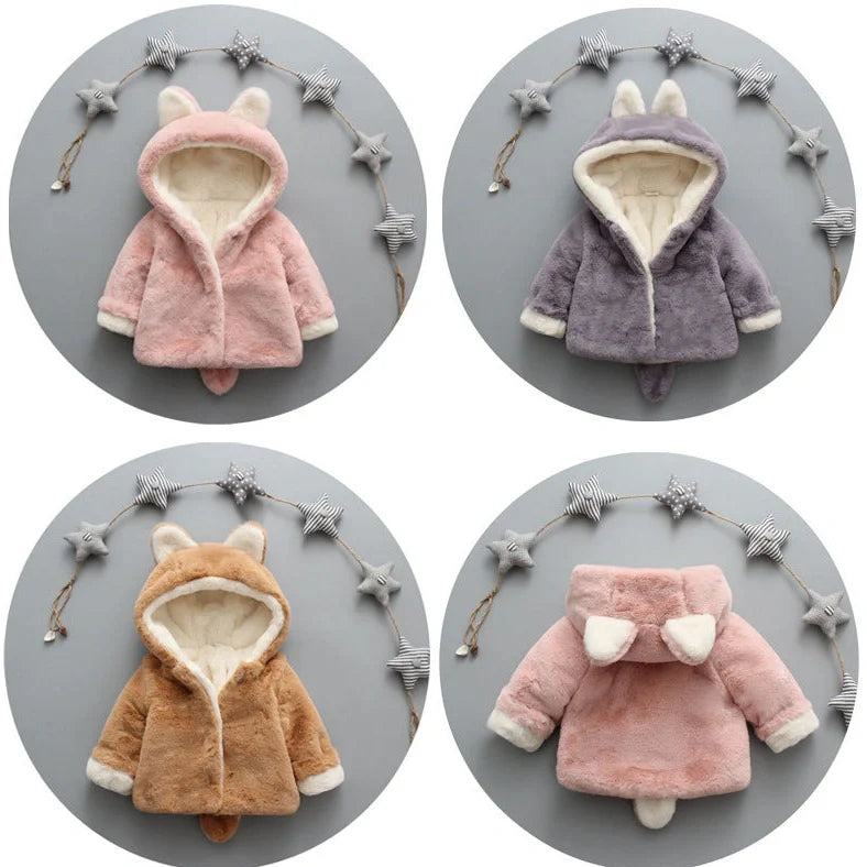 Baby wearing pink cotton coat with velvet accents, showing flocking fabric texture and cotton filling insulation