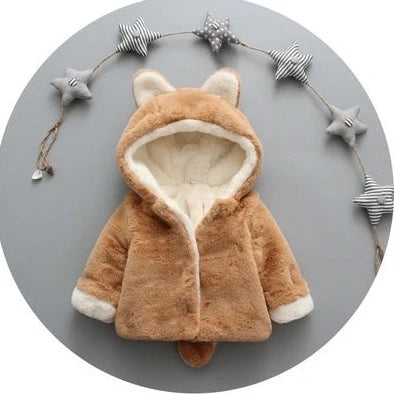 Baby wearing pink cotton coat with velvet accents, showing flocking fabric texture and cotton filling insulation