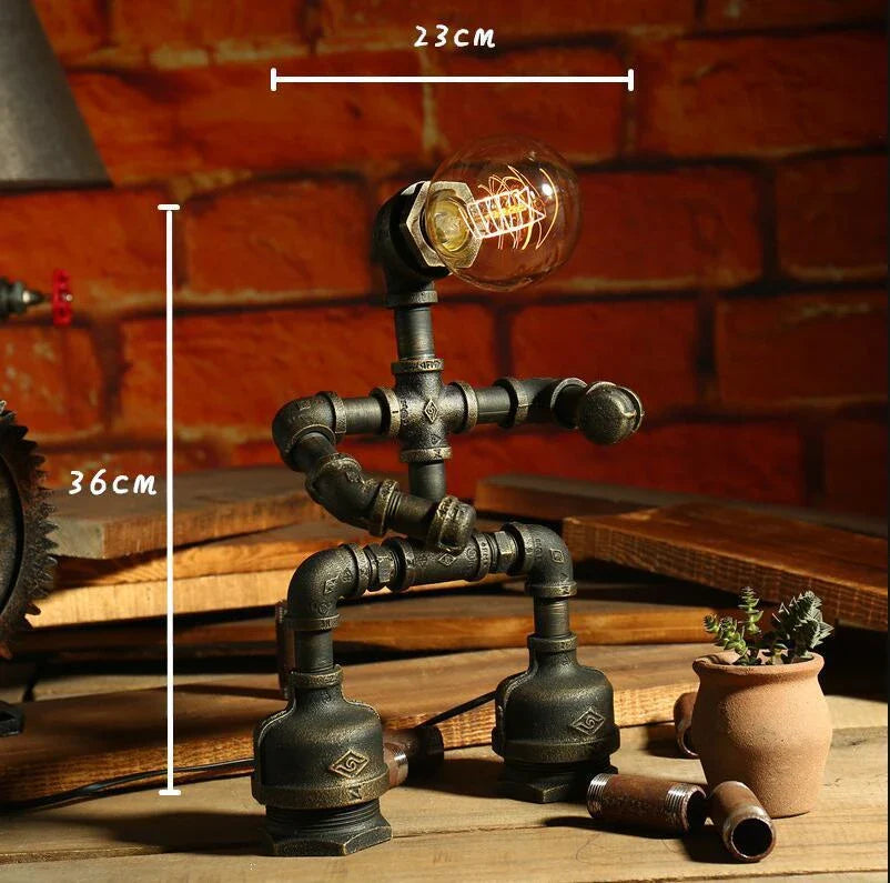 Vintage industrial iron pipe table lamp with soft, warm lighting and a green bronze finish