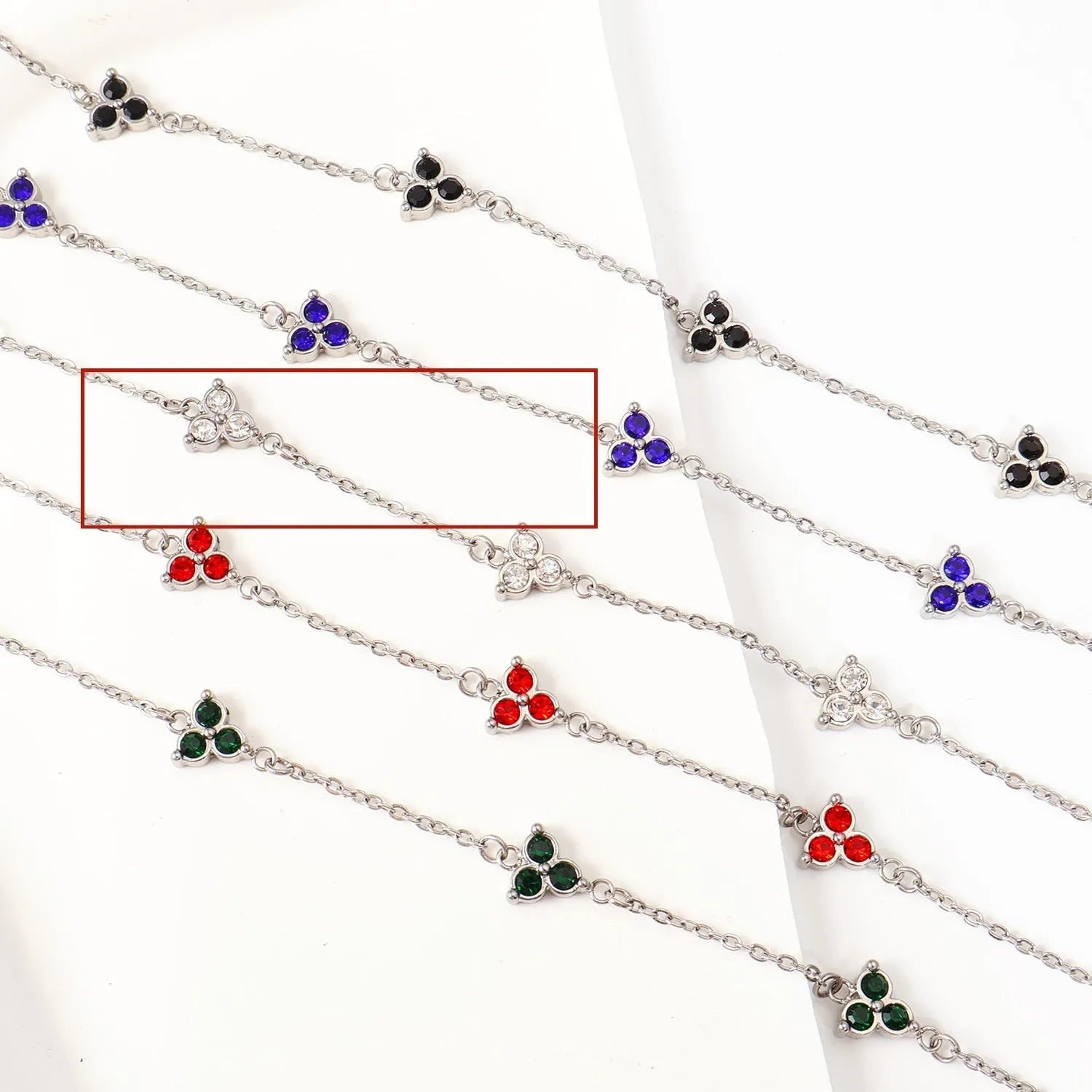 Women's stainless steel bracelet with three triangle-shaped charms in different coloured stone settings