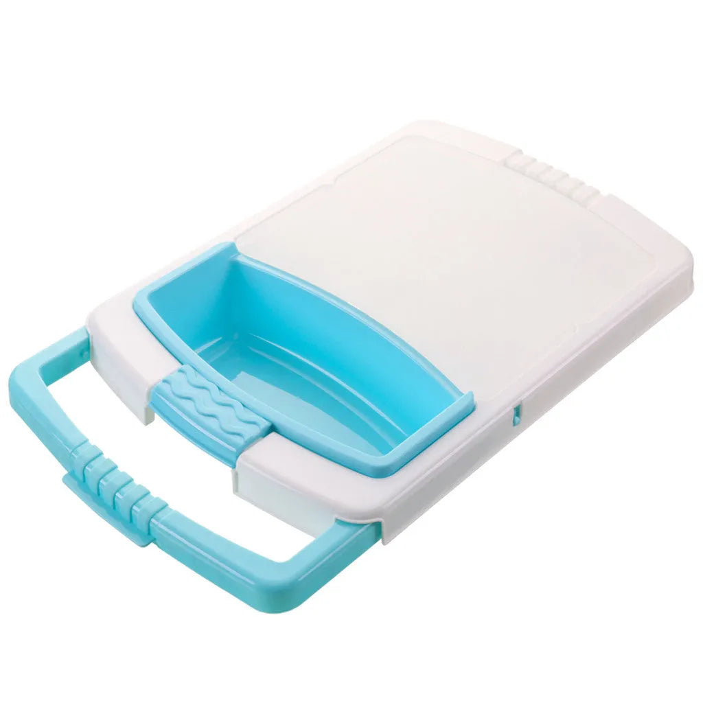 Green multifunction cutting board with drainage holes and storage trough mounted on a kitchen sink.