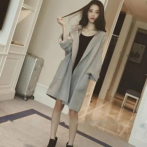Plus size woman wearing a grey thin cotton coat with lace details, loose fit, long sleeves.