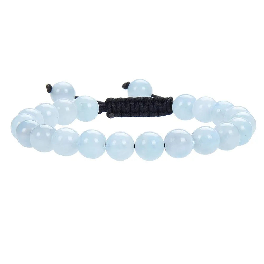 Close-up of a women's flat knot braided healing bracelet hand-woven with colourful gemstones.