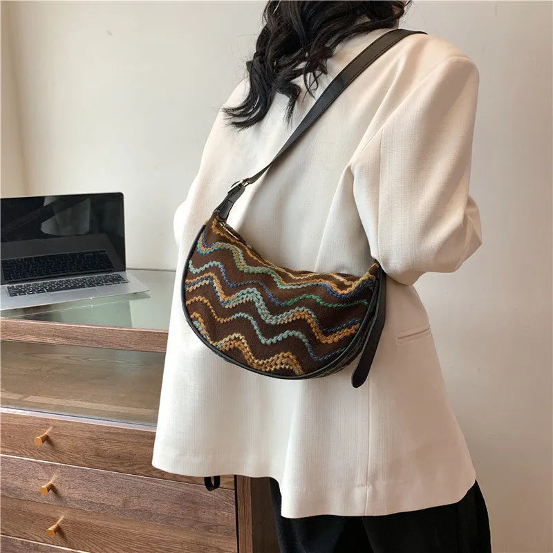 Women's woven straw crossbody bag with internal phone and file pockets in various colours.