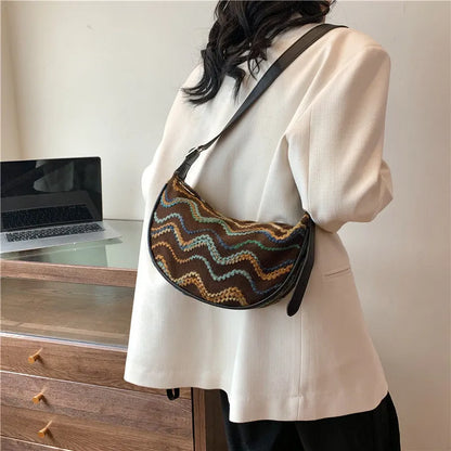 Women's woven straw crossbody bag with internal phone and file pockets in various colours.