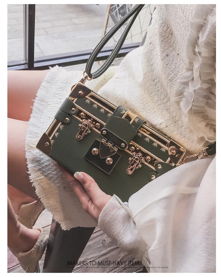 Women's hard flap shoulder bag in black or green with single adjustable strap and rivet decoration