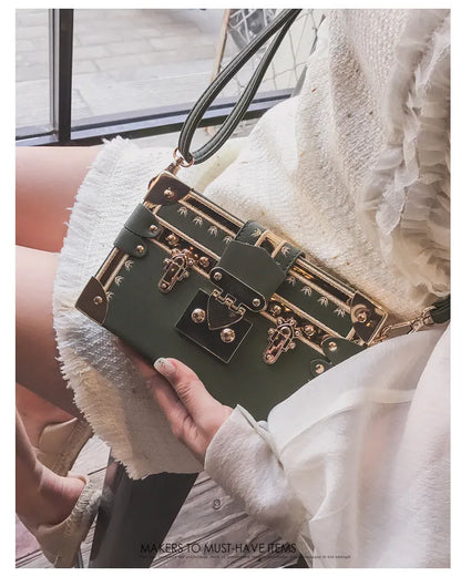 Women's hard flap shoulder bag in black or green with single adjustable strap and rivet decoration
