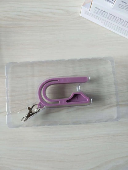 Plastic car seat key for child car seat red button, shown in Pink, Violet, or green, stored on a keychain.