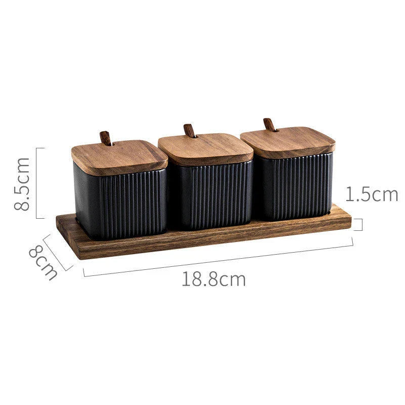 Elegant ceramic seasoning jars with wooden accents, providing stylish and organized storage for kitchen spices and herbs