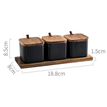 Elegant ceramic seasoning jars with wooden accents, providing stylish and organized storage for kitchen spices and herbs