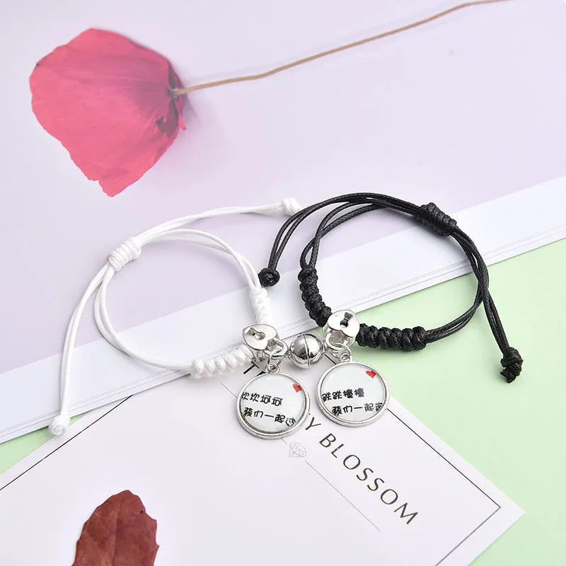 Magnetic suction couple bracelet pair in alloy with an electroplated finish, showing example designs like a crown and love lock.