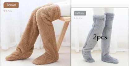 Cozy over-the-knee fuzzy socks in various colors, including brown, blue, dark gray, pink, silver, and more. Comfortable cotton design for warm, snug legs.