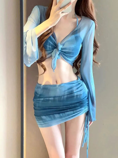 Women's blue high-waisted bikini four-piece set showing shirt, bra, underwear, and skirt pieces