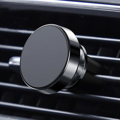 Aluminium alloy magnetic car phone holder mounted in a CD slot, holding a smartphone at an adjustable angle.