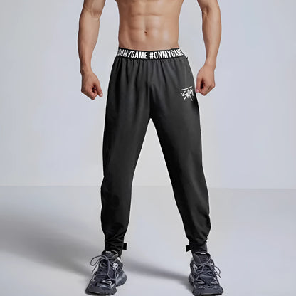 Women's loose sports cropped pants in grey with printed waistband for workouts and running activities