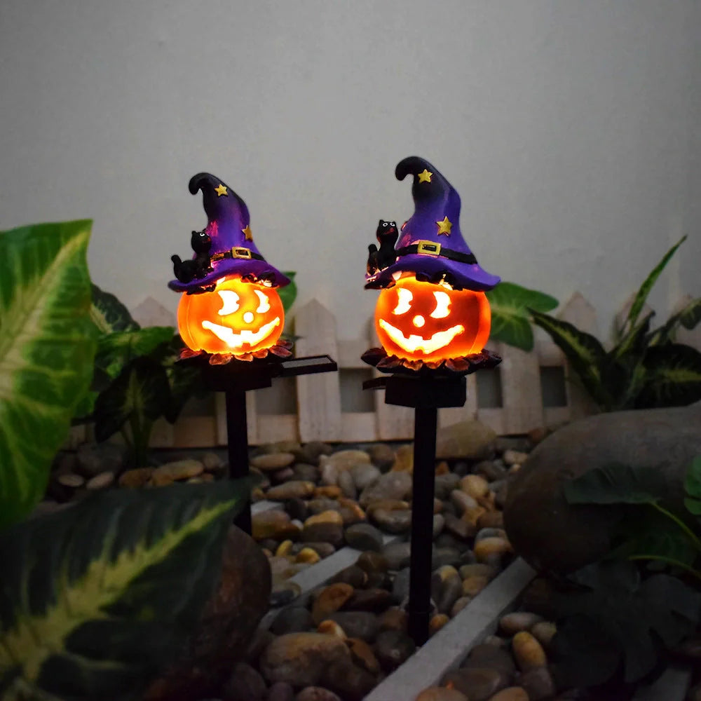 Solar-powered Halloween pumpkin lanterns lighting up a garden at night