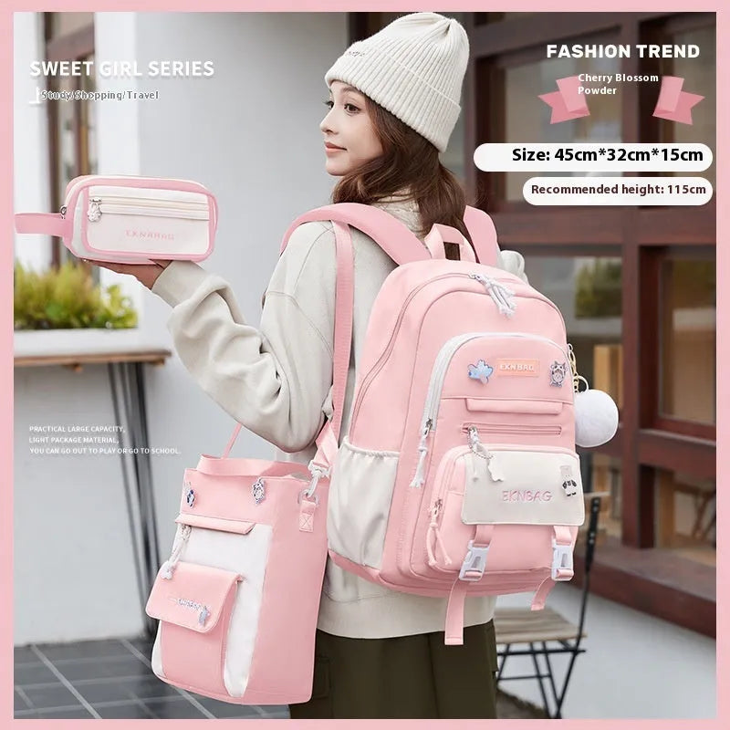 Pink waterproof Oxford cloth school backpack for girls with curved shoulder straps, shown with matching pencil case.