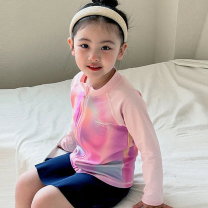 Girls' long sleeve swimsuit with split skirt in gradually varied pink colour, showing complete arm coverage and skirt design
