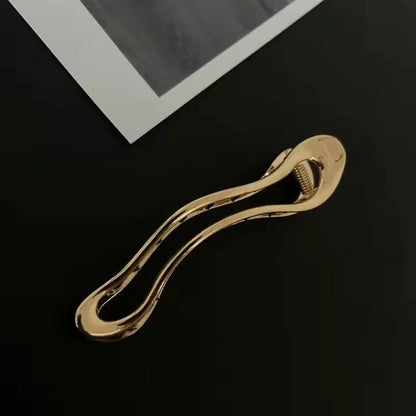 Women's gold and silver zinc alloy hair barrettes in arc, square, and triangle shapes.