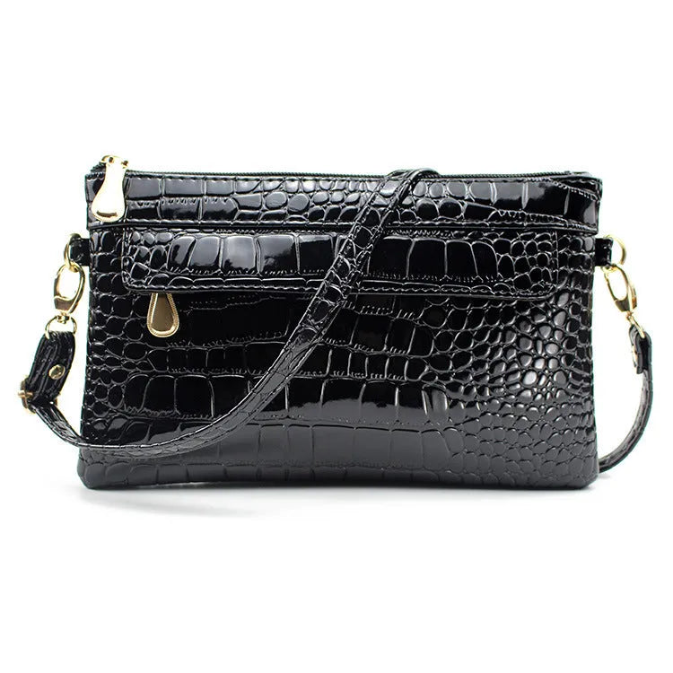 Women's black PU messenger bag showing horizontal square shape and shoulder strap
