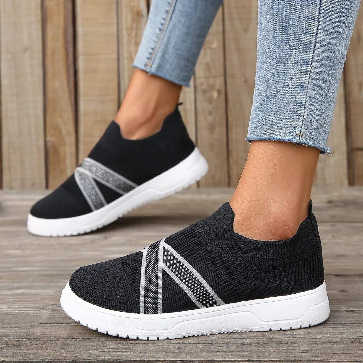 Black women's flyknit mesh flat shoes with rubber sole and tassel detail