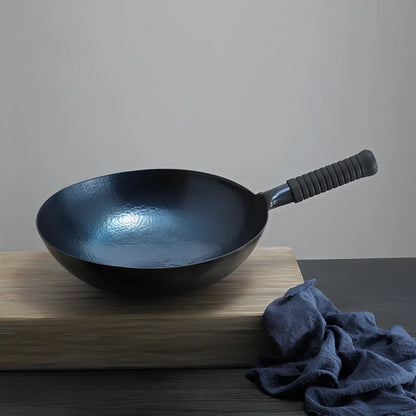 One-piece iron cooking pan with uncoated surface in hot forged silver white or roasted blue finish