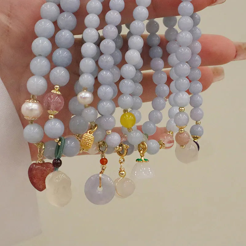 Gold plated women's bracelet with artificial crystal aquamarine chalcedony pendant in climbing cat design