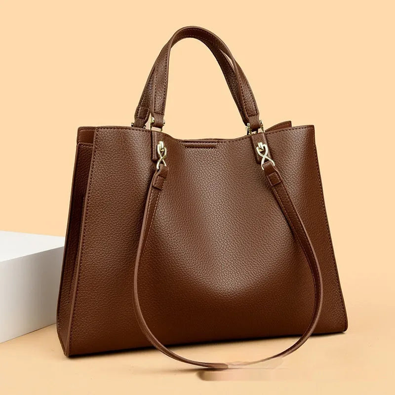 Women's horizontal square messenger tote bag in PU leather with crossbody strap and internal compartments.