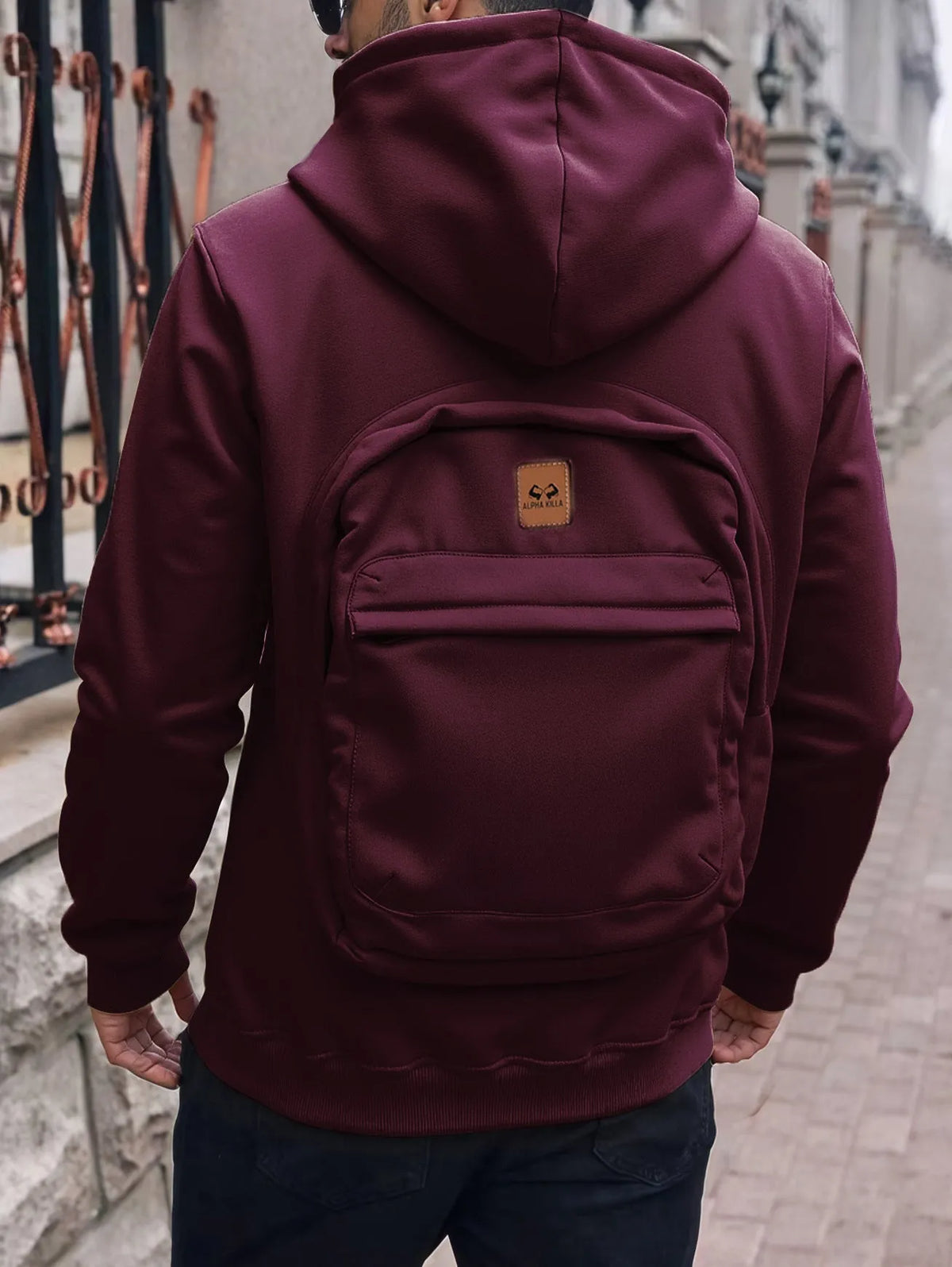 Men's loose-fit hoodie cardigan sweater with back schoolbag design and stick pocket in light grey, black and blue.