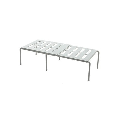 White telescopic kitchen storage rack at adjustable height on a countertop