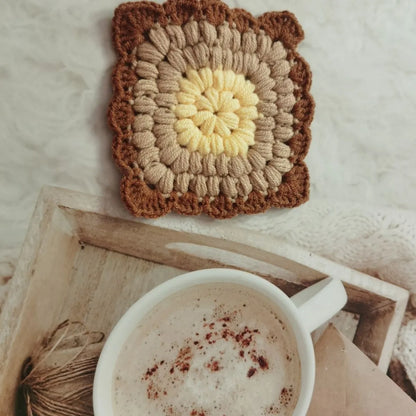Crocheted wool cup coaster with grandmother lattice pattern in selected colour