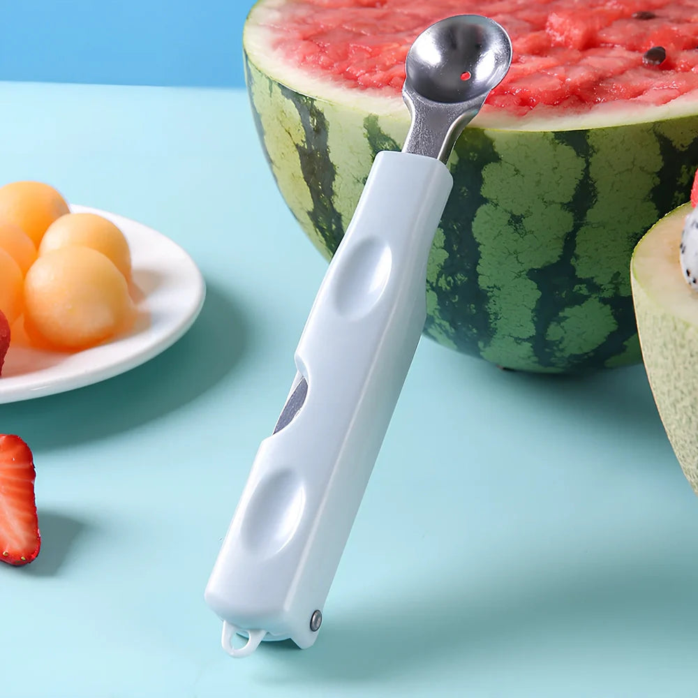 Three-in-one stainless steel watermelon ball digger in grass green, 24cm long with hidden knife and 10cm scoop for fruit slicing