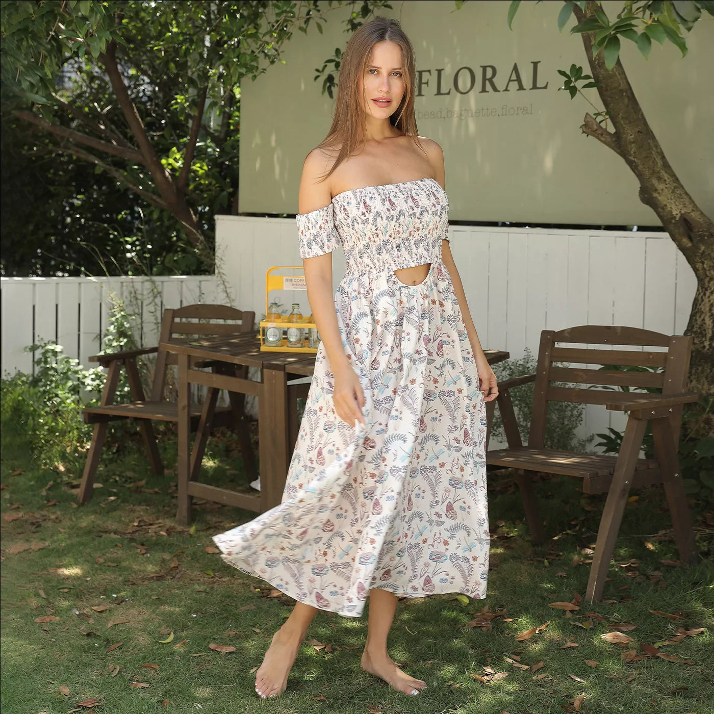 Women's off shoulder strapless floral dress in a lightweight fabric, available in multiple sizes.