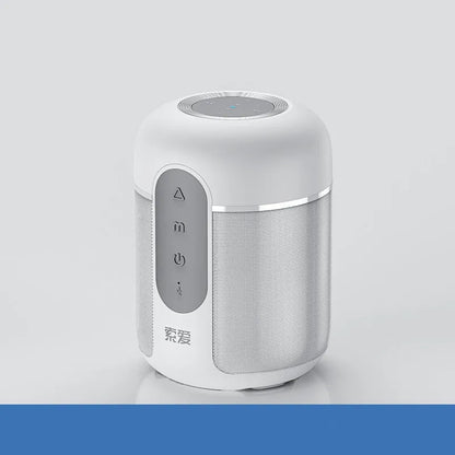 Small black portable Bluetooth speaker showing front grille and control buttons on a table.